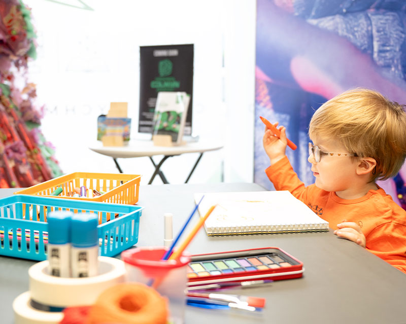 Young boy enjoying himself taking part in craft at Creadigol Colwyn Creative