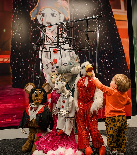 Young Boy interacting with theatre puppets
