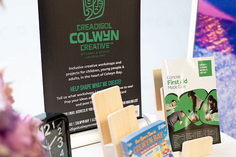 Creadigol Colwyn Creative  table with signage and information leaflets